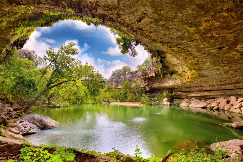 The Best Neighborhoods in Austin and Central Texas for Families Relocating for Work 3 a pool and grotto with clear blue water